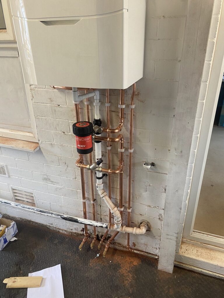 Boiler installation with magnetic filter and copper pipework, fitted by CMG