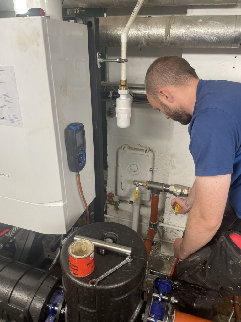Chris Greenhalgh servicing a commercial boiler with a flue gas analyser