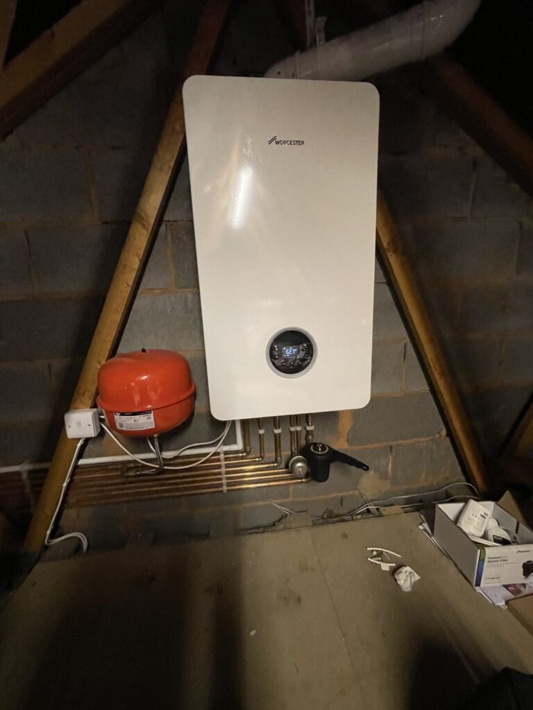 Worcester Bosch boiler installed in a loft with expansion vessel and neat copper pipework, by CMG Heating & Plumbing